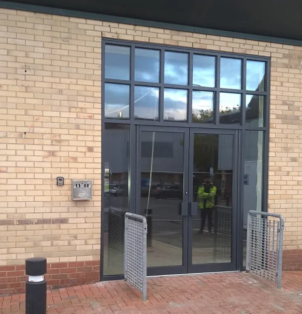 Anthracite grey aluminium commercial entrance doors with glazed overhead panels