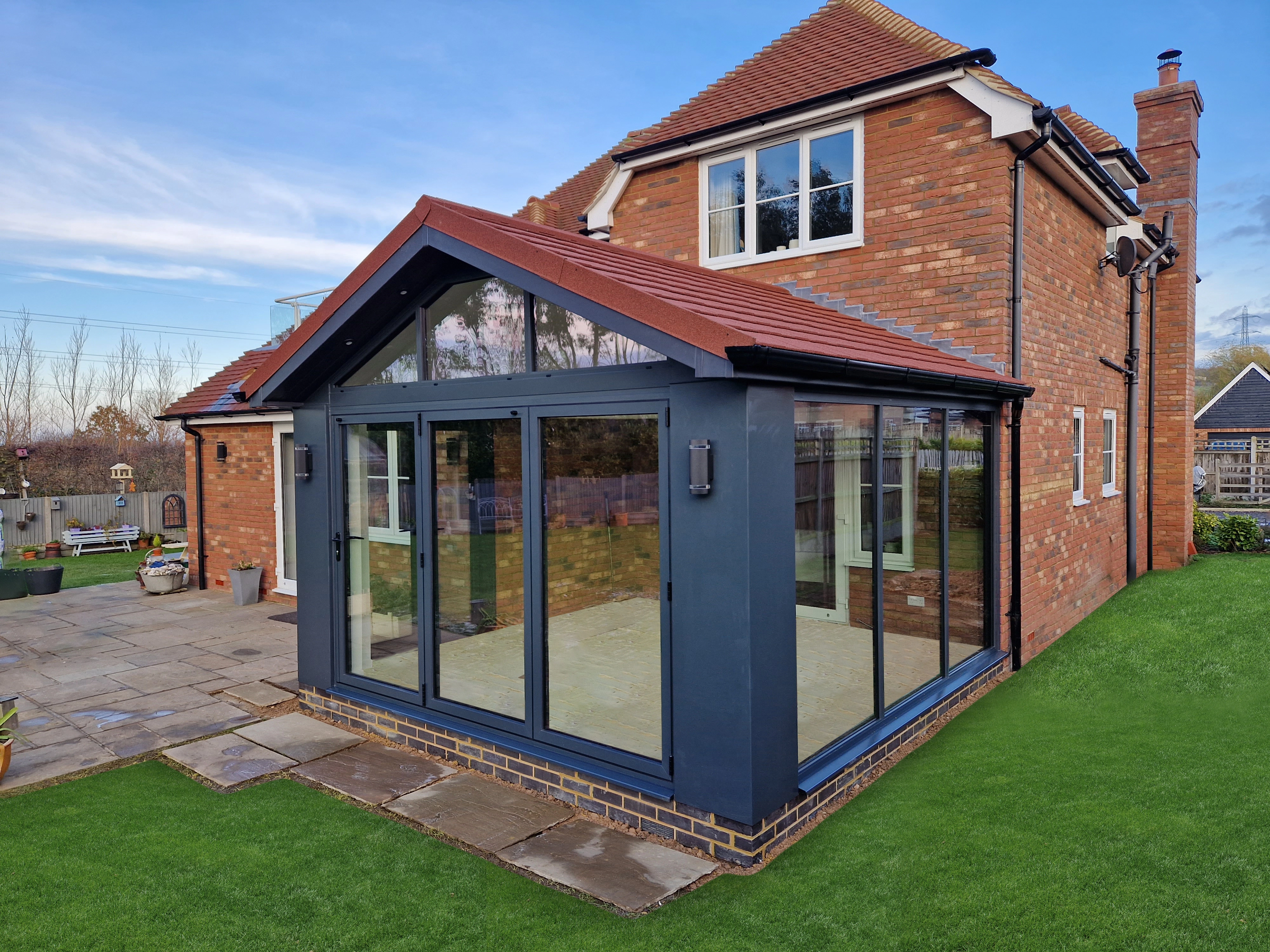 Anthracite grey aluminium orangery extension with a matching tiled roof